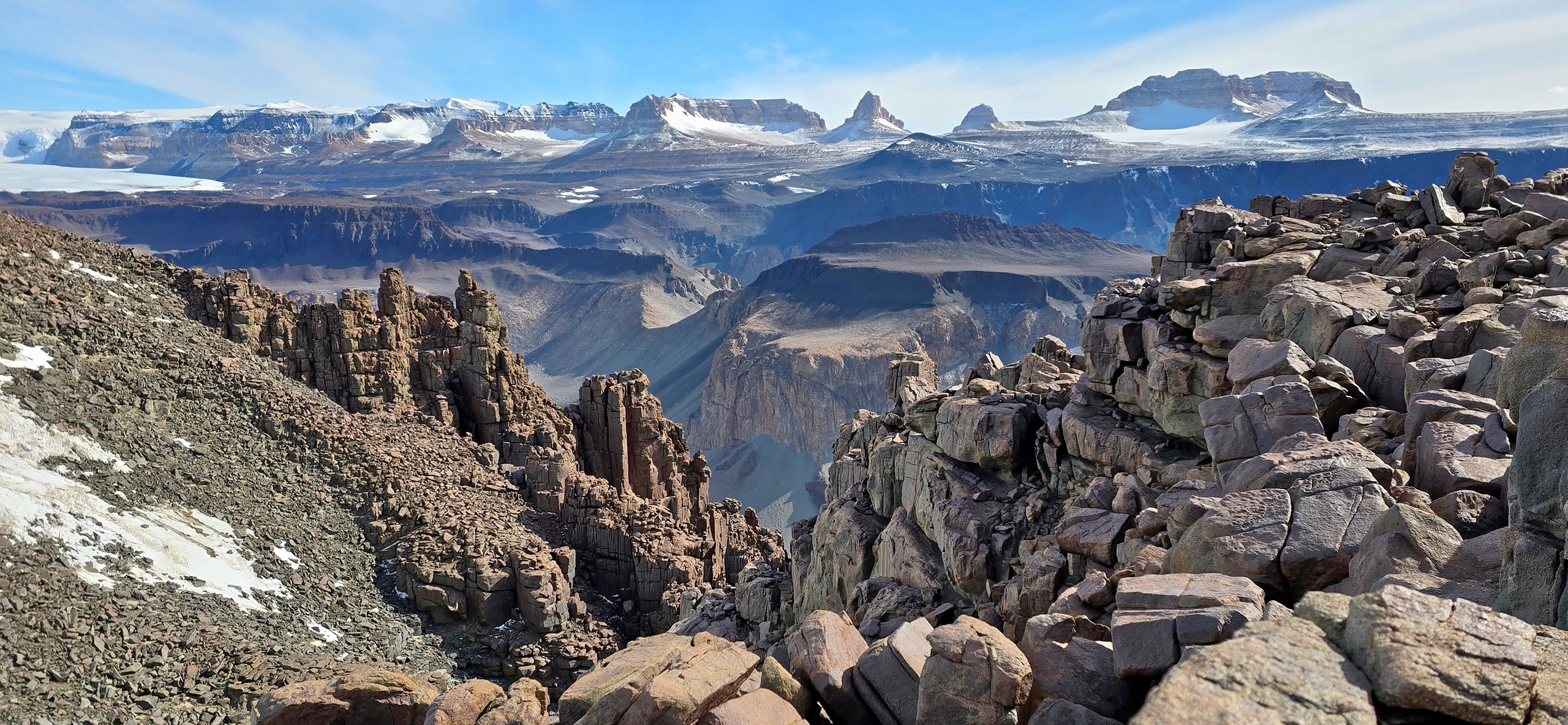 Looking north across the Wright valley, with an outcrop of the Peneplain sill – an intrusion of magma between rock layers – in the foreground.   