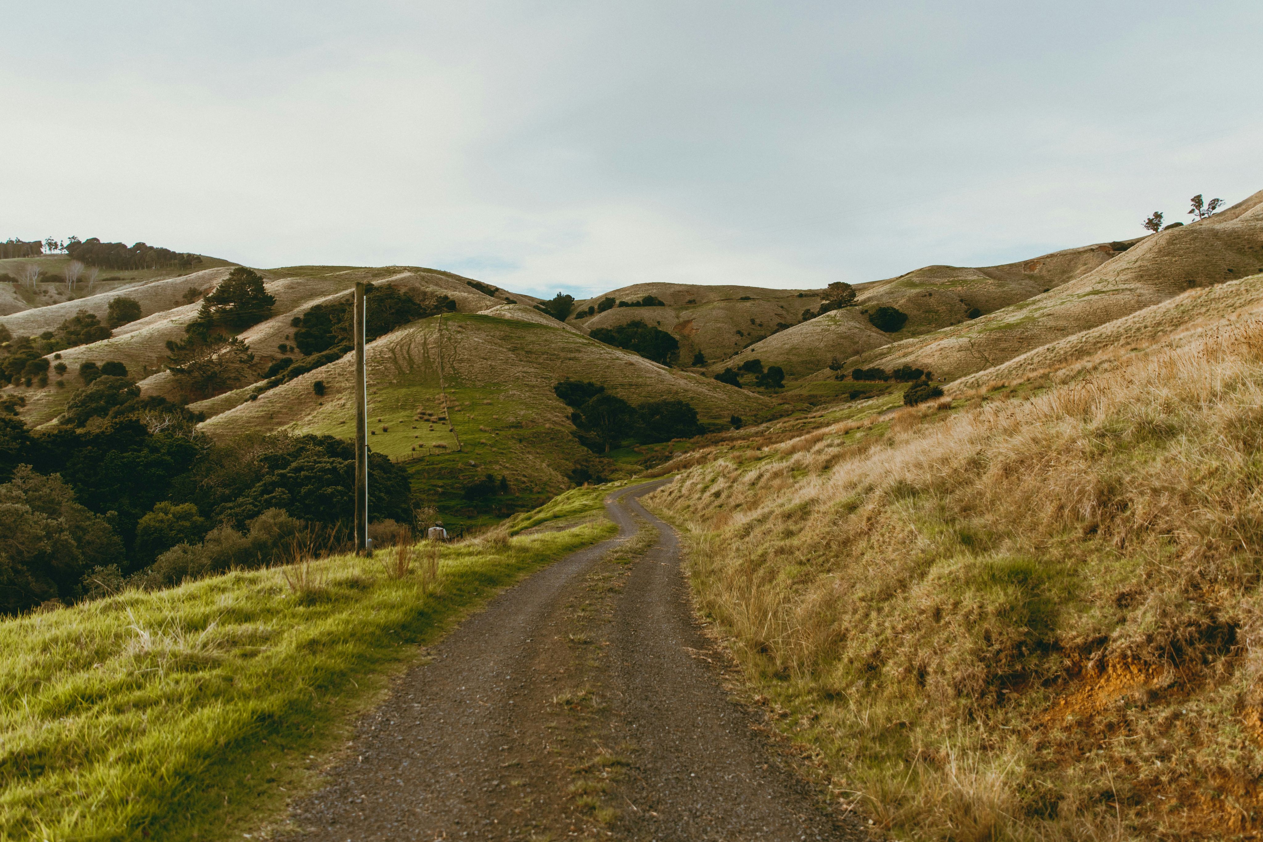 a dirt road in the middle of a hilly area