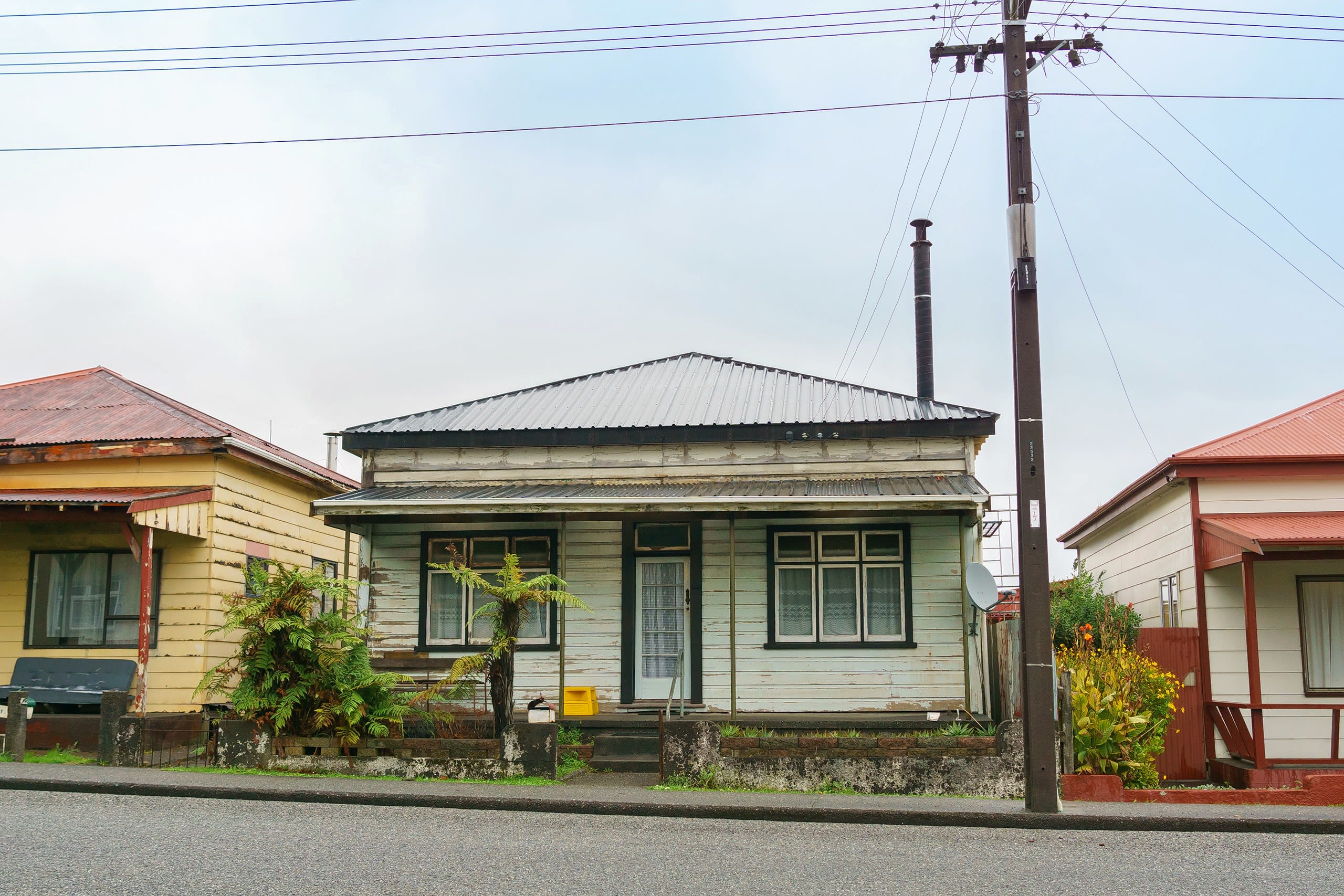 A squart front cottage in a poor state of repair.