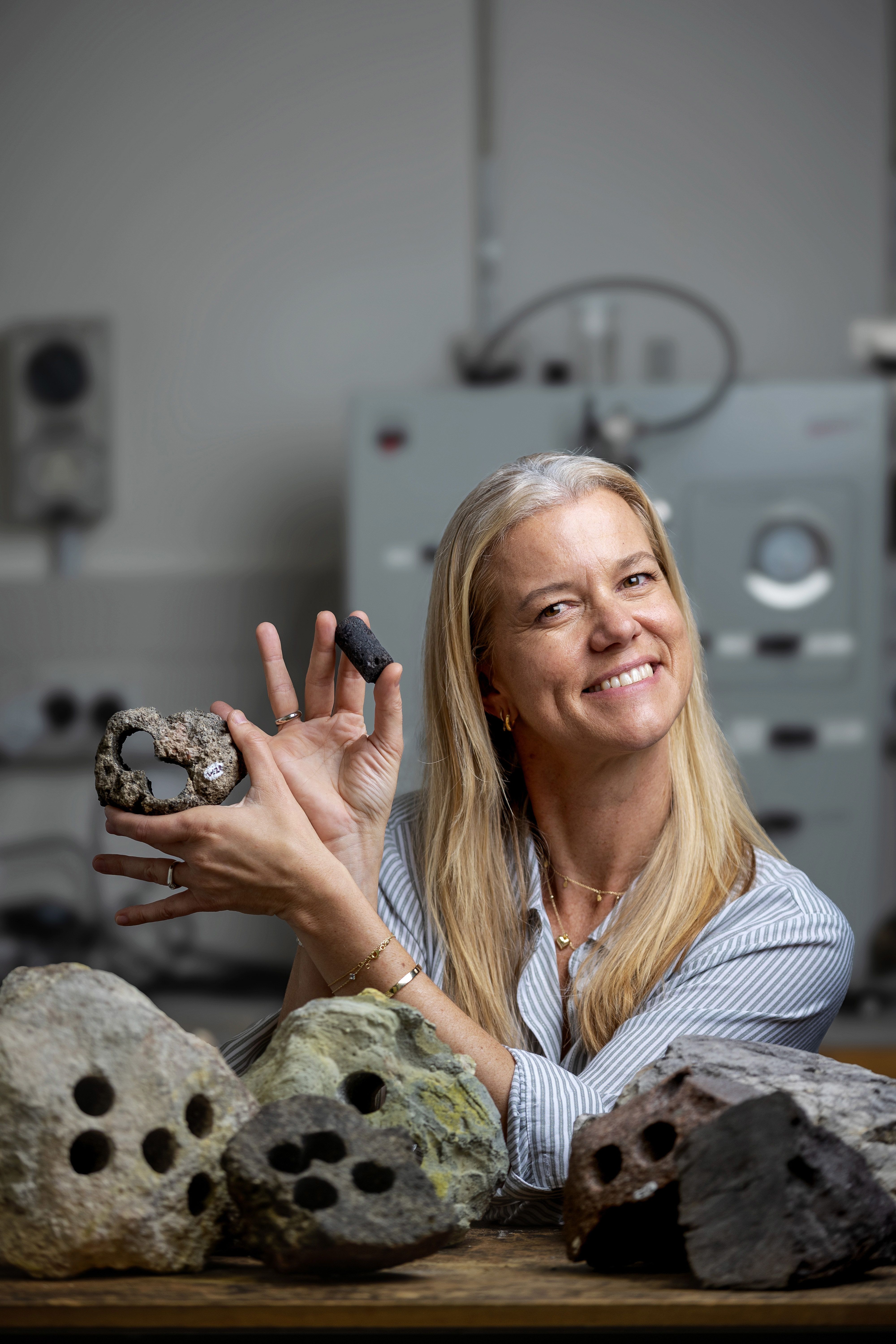 Associate Professor Mila Adam holding porous rock