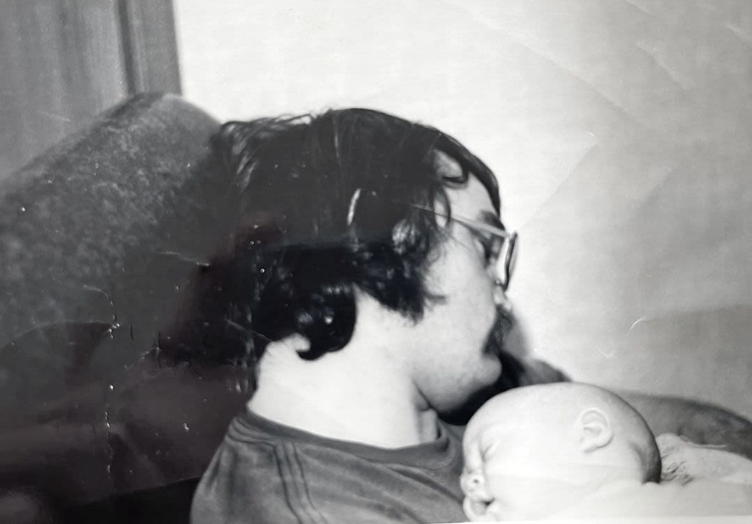 NEW DAD: Charlie Wright cradles baby Amanda.